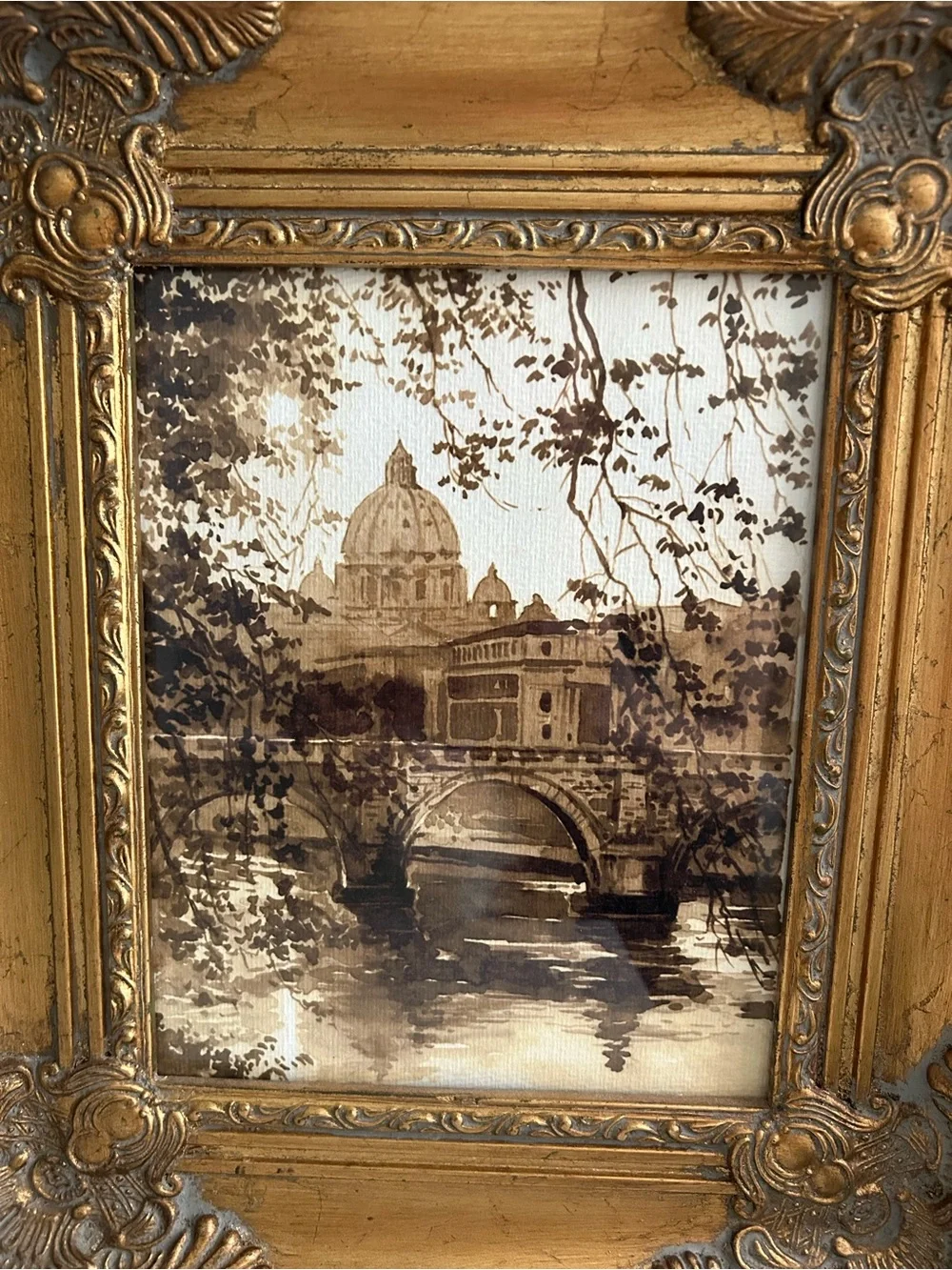Framed art in gilded ornate frame